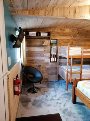 a room with two bunk beds and a desk at Pensalda Guest House in Newquay