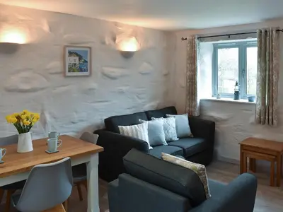 a living room with a couch and a table at Willow - 31287 in Porthtowan