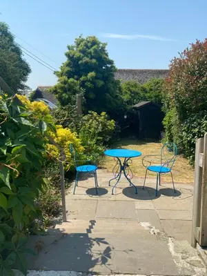 a table and two chairs and a blue table and chairs at Froglets in Tregoney