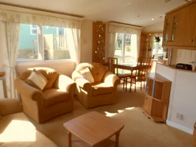 a living room with two chairs and a table at Peace and quiet in countryside location near Perranporth in Perranzabuloe