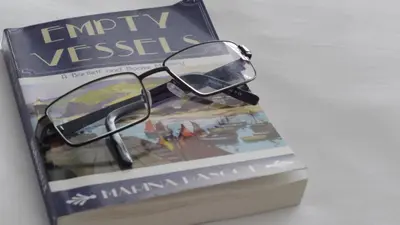 a pair of glasses sitting on top of a book at Falmouth Bay in Falmouth