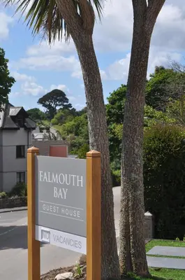 a sign for a fallhill bay guest house at Falmouth Bay in Falmouth