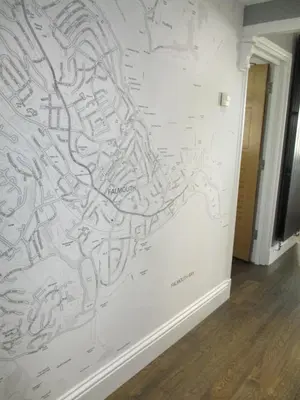 a wall with arawl drawings on it at Falmouth Bay in Falmouth