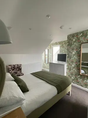 a bedroom with a large bed and a television at Falmouth Bay in Falmouth