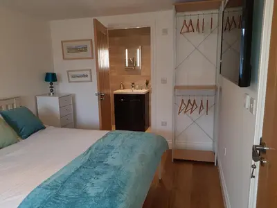 a bedroom with a bed and a sink in it at Primrose House in St Ives