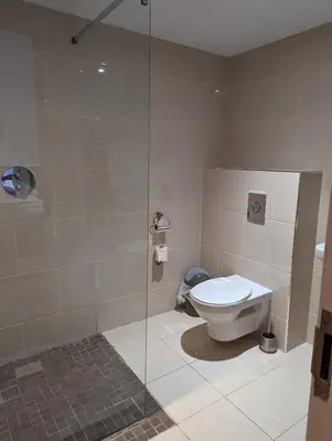 a bathroom with a toilet and a glass shower at Barley Sheaf, Old Bridge Street EN SUITE ROOMS, ROOM ONLY in Truro