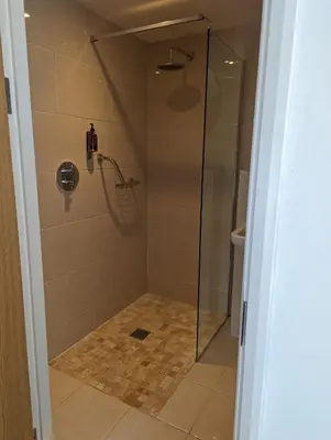 a shower with a glass door in a bathroom at Barley Sheaf, Old Bridge Street EN SUITE ROOMS, ROOM ONLY in Truro