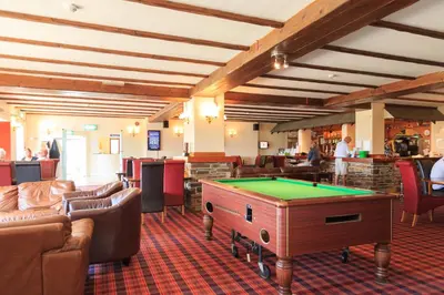 a billiard room with couches and a pool table at Bowood Park Hotel in Camelford