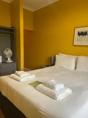 a bed with two towels on top of it at Bowood Park Hotel in Camelford