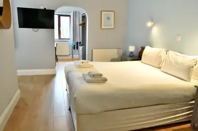 a bedroom with a large bed with towels on it at Bowood Park Hotel in Camelford