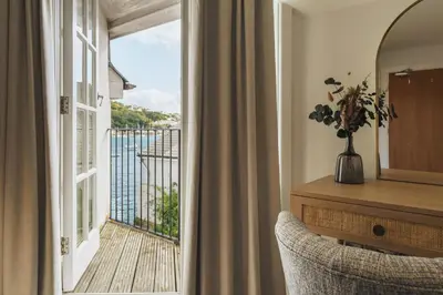 a room with a view of a balcony at The Old Quay House Hotel in Fowey
