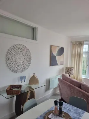 a living room with a couch and a table at Halwyn View in St Austell