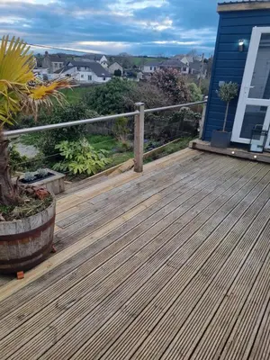 a wooden deck on the front of a house at Halwyn View in St Austell
