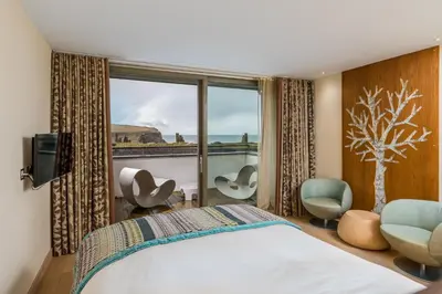 a hotel room with a bed and a window at Scarlet Hotel - Adults Only in Mawgan Porth