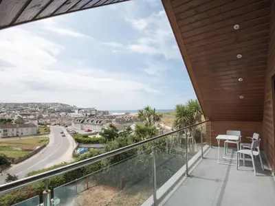 a balcony with a view of a city at Lyndhurst in Perranporth