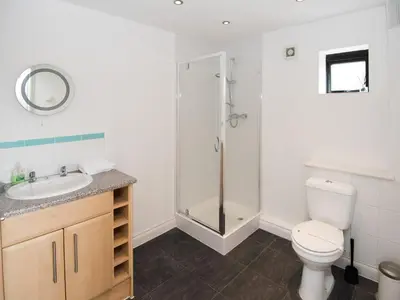 a bathroom with a toilet sink and a shower at Lyndhurst in Perranporth