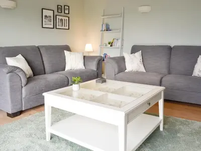 a living room with a couch and a coffee table at Lyndhurst in Perranporth