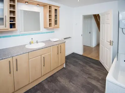 a bathroom with a sink and a mirror at Lyndhurst in Perranporth