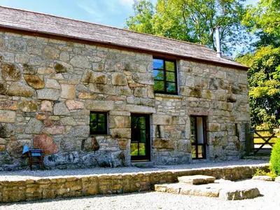 an old stone building with windows at Trevellyan Barn in Lanivet
