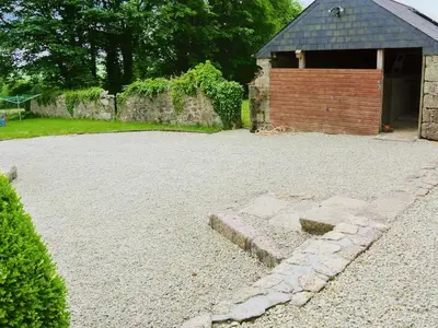 a gravel driveway with a building in the background at Trevellyan Barn in Lanivet