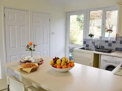 a kitchen with a bowl of fruit on a counter at Moonrakers in Ruan Lanihorne