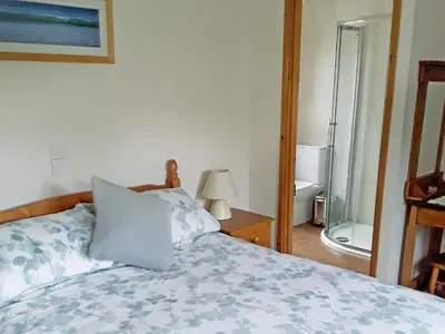 a bedroom with a bed with a pillow on it at Little Lookover in Saint Columb Minor