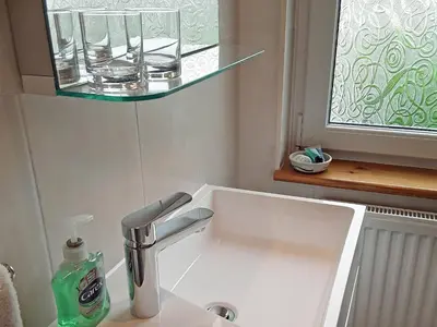 a bathroom sink with a faucet and a window at Little Lookover in Saint Columb Minor