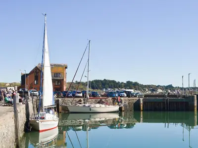 two sailboats are docked in a marina at Little Tregarthen in Padstow