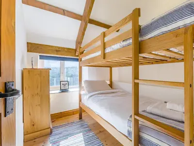 a bedroom with bunk beds in a house at Jarvies Cottage in Boscastle