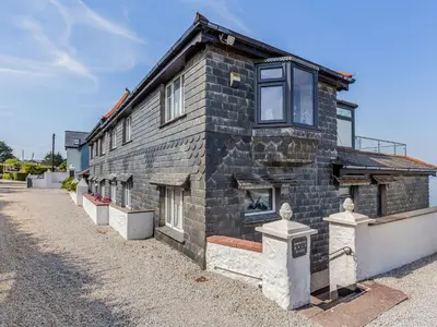 a brick building with windows on the side of it at Studio Sea Urchin in Carbis Bay