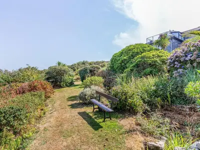 a bench sitting on the side of a hill at Studio Sea Urchin in Carbis Bay