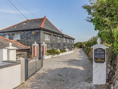 an old house with a sign in front of it at Studio Sea Urchin in Carbis Bay