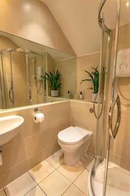 a bathroom with a toilet and a sink and a shower at Porth Sands Beachfront Apartment in Newquay