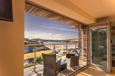 a balcony with a view of the ocean at Porth Sands Beachfront Apartment in Newquay