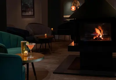 a fireplace in a living room with a fire place at Esplanade Hotel in Newquay