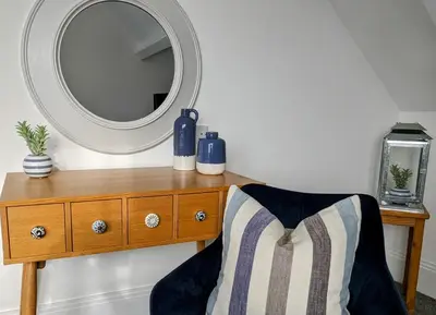 a dressing table with a mirror and a chair at The Westcott by the Sea - Just for Adults in Falmouth