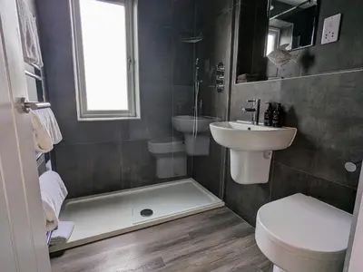 a bathroom with a sink and a toilet and a shower at The Westcott by the Sea - Just for Adults in Falmouth
