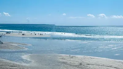 a group of people on a beach near the water at Camellia Chalet in Germoe
