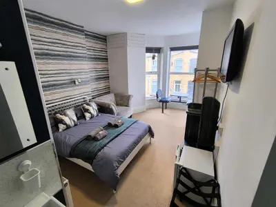 a bedroom with a bed and a tv in it at Sea Bed Guesthouse in Newquay