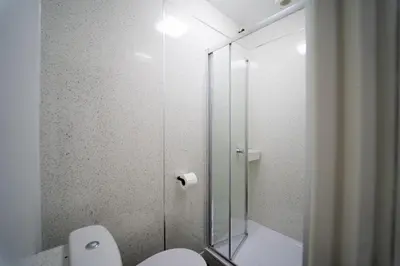 a bathroom with a toilet and a glass shower at Sea Bed Guesthouse in Newquay