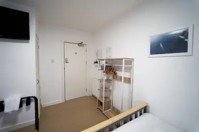 a room with a bed and a book shelf at Sea Bed Guesthouse in Newquay