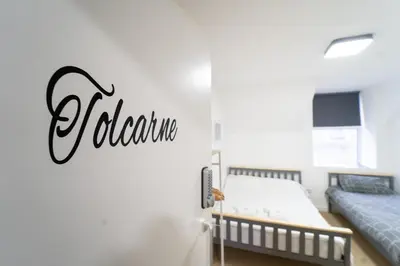 a bedroom with a bed and a sign that reads adrenaline at Sea Bed Guesthouse in Newquay