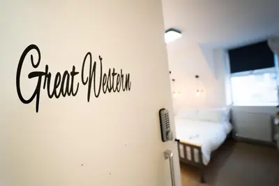 a bedroom with a bed and a sign that reads cheatulum at Sea Bed Guesthouse in Newquay