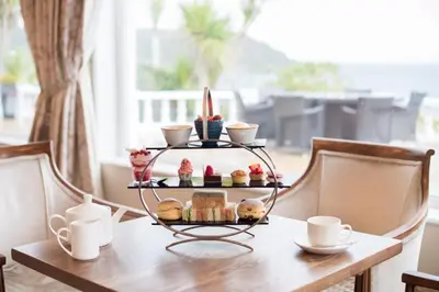 a table with a tray of pastries and cups on it at The Royal Duchy Hotel in Falmouth