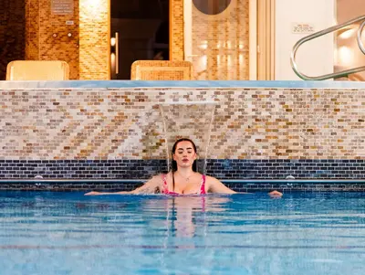 a woman in a swimming pool at The Carlyon Bay Hotel and Spa in St Austell