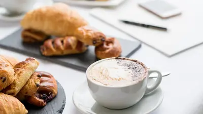 a cup of coffee and pastries on a table at The Carlyon Bay Hotel and Spa in St Austell