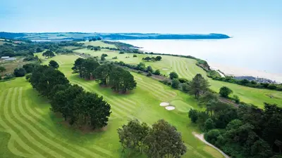 an aerial view of a golf course next to the ocean at The Carlyon Bay Hotel and Spa in St Austell