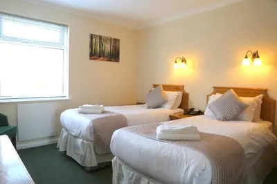 a hotel room with two beds and a window at Westberry Hotel in Bodmin
