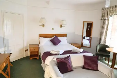 a hotel room with a bed and a mirror at Westberry Hotel in Bodmin