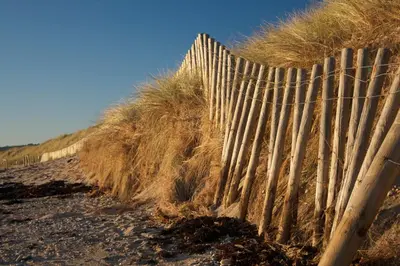 a wooden fence on the side of a beach at Wenden Guest House in Newquay